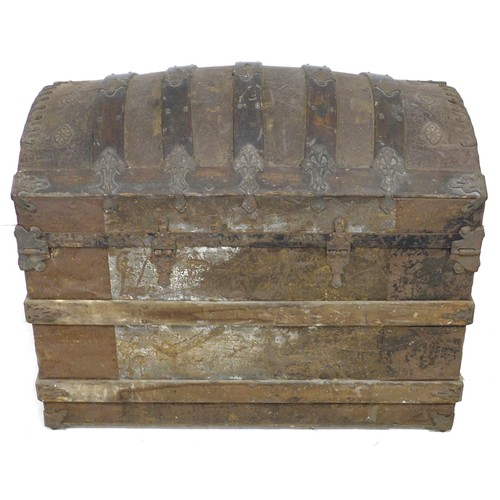 170 - A 20th century dome topped storage chest, with wooden supports and embossed with metal decorative ap... 