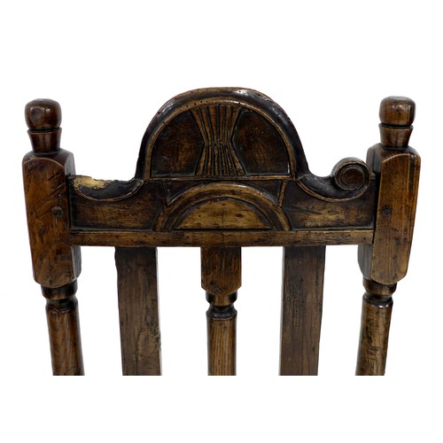 171 - An 18th century oak hall chair, the high back with three splats, below a carved top rail, a solid se... 