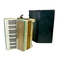 A vintage Hohner Tango piano accordion, with original case.