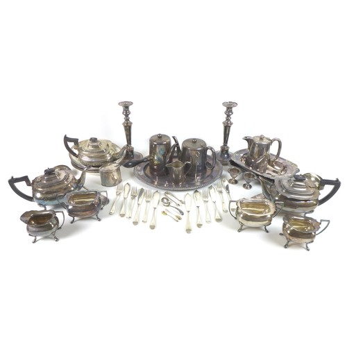 96 - A large collection of silver plated items, including tea sets, flatware, a pair of candlesticks, tra... 