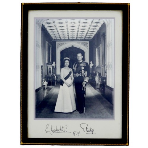 A 1979 photograph of HRH Queen Elizabeth II and Prince Philip, purportedly signed by the late Queen and Duke of Edinburgh, 28.5 by 21cm, framed, 31.5 by 24cm, given to Ruben Harry Henson, a coach trimmer for the Royal Train on his retirement, together with a photograph of recipient with other crew members, unframed, 12.5 by 17cm. (2)