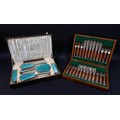 A George V silver and enamel dressing table set, comprising a mirror and four brushes with vintage f... 
