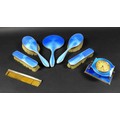 An Art Deco dressing table set, with blue enamel decoration, comprising a hand mirror, two hair brus... 