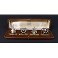 Four silver nautical menu holders by Harrods of London, two anchors, two ship's wheel, approximately... 