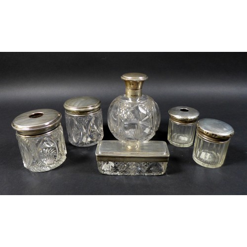 8 - A collection of silver lidded cut glass dressing table jars, including a four piece set by Walker & ... 