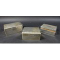 A group of three Edwardian silver cigarette boxes, machine turned decorations to lid, with cedar woo... 