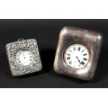 Two late Victorian silver cased travel clocks, both with easel frames and silver fronts, both contai... 