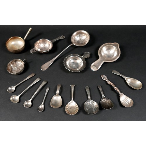 29 - A group of mixed silver and white metal items, including caddy spoons, tea strainers, salt spoons, a... 