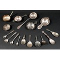 A group of mixed silver and white metal items, including caddy spoons, tea strainers, salt spoons, a... 
