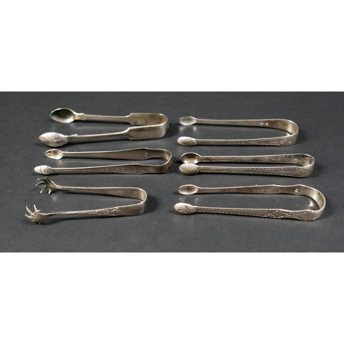 15 - A group of six 18th and 19th century silver sugar tongs, including bright cut engraved and claw foot... 