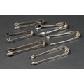 A group of six 18th and 19th century silver sugar tongs, including bright cut engraved and claw foot... 