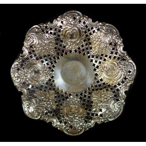 36 - A silver bon bon dish, with foliate and scroll designs and pierced decoration to its bowl, raised up... 
