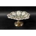 A silver bon bon dish, with foliate and scroll designs and pierced decoration to its bowl, raised up... 