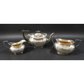 A Victorian three piece silver tea set, comprising a teapot, 27 by 11 by 15.5cm high,milk jug and su... 