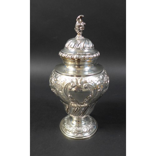 35 - A Victorian silver urn, with conch shell finial and profuse floral repousse decoration and two blank... 