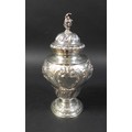 A Victorian silver urn, with conch shell finial and profuse floral repousse decoration and two blank... 