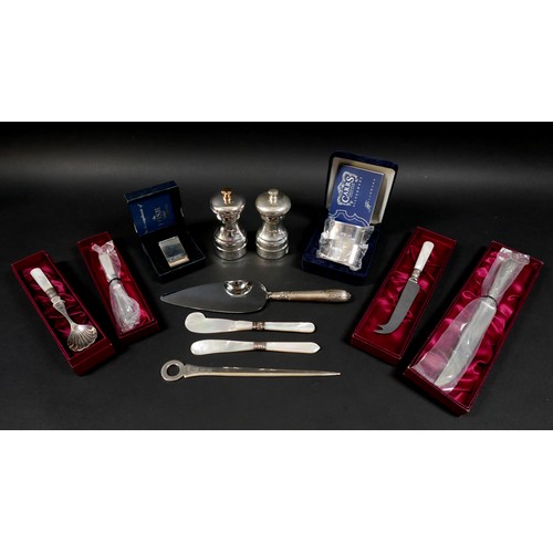25 - A collection of ERII silver, including a pair of napkin rings with case and still in plastic wrappin... 