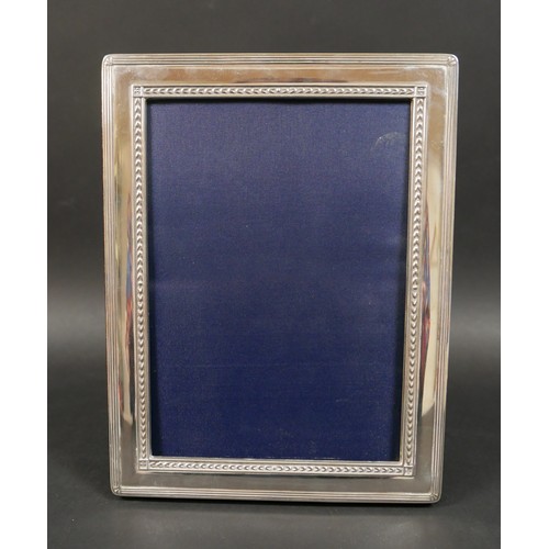 33 - Six Edwardian and later silver photograph frames, including an Edwardian frame with ribbon deocratio... 