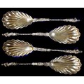 A cased set of four Victorian silver decorative serving spoons, with scalloped bowls, twist stems an... 