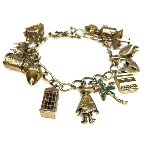 243 - A 9ct gold charm bracelet, with padlock clasp and safety chain, 37.1g overall, chain length 18cm.