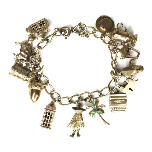 243 - A 9ct gold charm bracelet, with padlock clasp and safety chain, 37.1g overall, chain length 18cm.