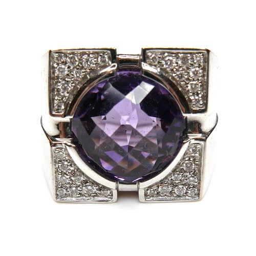 252 - A Versace 18ct white gold ring, set with a circular faceted cut amethyst, 13.5 by 7.5mm, within diam... 