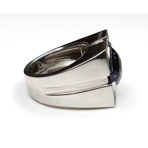 252 - A Versace 18ct white gold ring, set with a circular faceted cut amethyst, 13.5 by 7.5mm, within diam... 