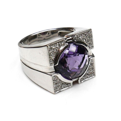 252 - A Versace 18ct white gold ring, set with a circular faceted cut amethyst, 13.5 by 7.5mm, within diam... 