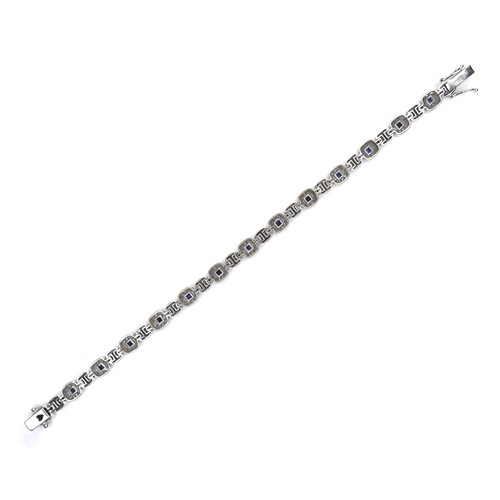 250 - An 18ct white gold, sapphire and diamond bracelet, fourteen cushion shaped panels, each set with a s... 