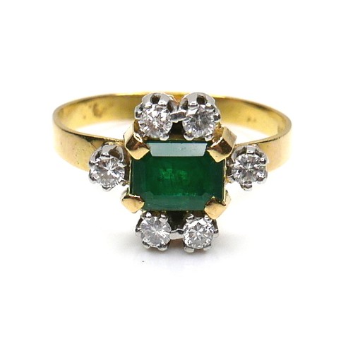 253 - An 18ct gold, emerald and diamond ring, the central Colombian emerald cut stone of of approximately ... 