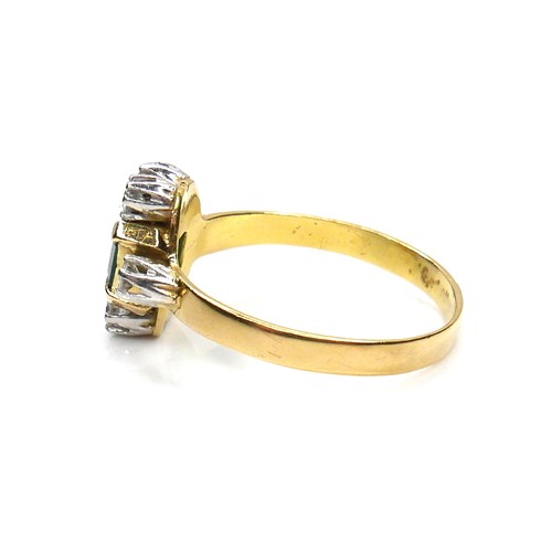 253 - An 18ct gold, emerald and diamond ring, the central Colombian emerald cut stone of of approximately ... 