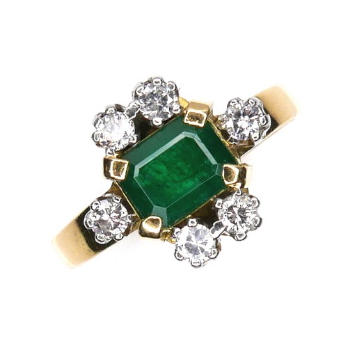 253 - An 18ct gold, emerald and diamond ring, the central Colombian emerald cut stone of of approximately ... 