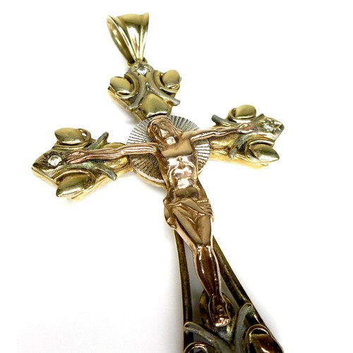 244 - A 14k yellow, rose, and white gold crucifix pendant, set with four diamonds to each arm, surrounding... 