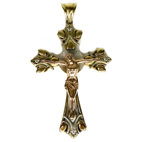 244 - A 14k yellow, rose, and white gold crucifix pendant, set with four diamonds to each arm, surrounding... 