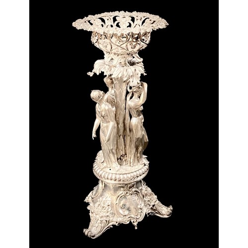 A Victorian silver centrepiece, the pierced basket supported on a column above three classical female figures, on a rococo scrolling three footed base with presentation inscription in Latin dated 1858 to Rev. William Dobson of Cheltenham College, J E Terrey & Co (John Edward Terry), London 1847, 121.5toz, 24.5 by 52cm high, in its original oak fitted storage case.

Provenance: sold on behalf of Rev. Dobson's family, Dobson was the second principal of Cheltenham College (1845-59), he received the silver centre-piece in recognition for his service as principal, although it was reported on his retirement in 1859 'he did not ask for a service of plate, but for a handsome and comfortable brougham and pair' (Rev. T. Mozley 'Reminscences' pub. circa 1882).
