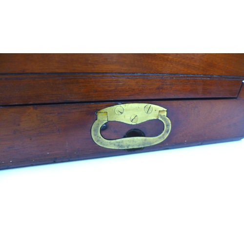 72 - A Georgian mahogany writing slope, with secret drawer and brass campaign handles, 44 by 29 by 13.5cm... 