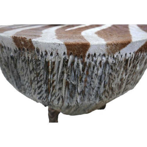 191 - Two East African zebra skin drums, the larger drum table, supported by three legs, with zebra mane r... 