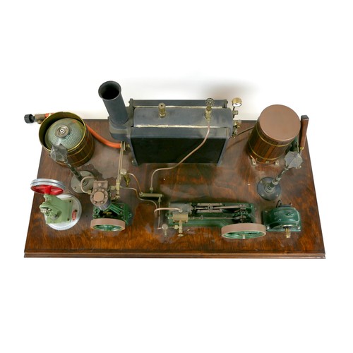 107 - A live steam engine display layout, mounted to a wooden base, with Stuart horizontal single piston e... 