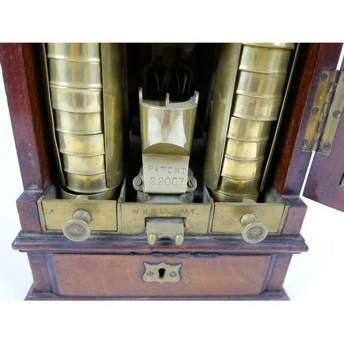 70 - A Victorian Sovereign change machine 'W. H. Ell's Patent Safecheck', the mahogany cabinet with glaze... 