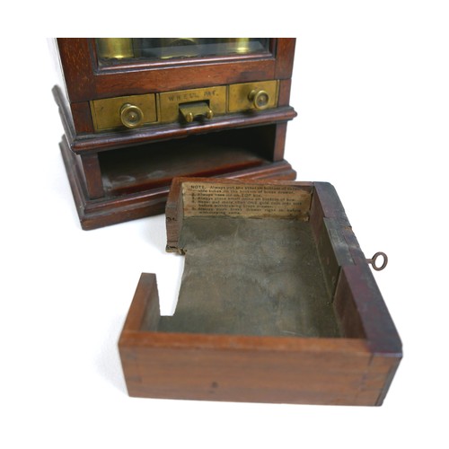 70 - A Victorian Sovereign change machine 'W. H. Ell's Patent Safecheck', the mahogany cabinet with glaze... 