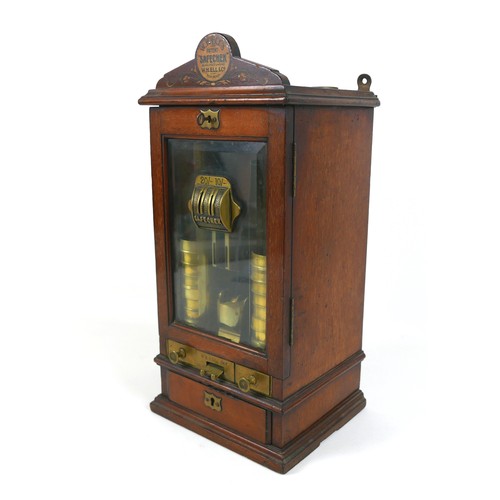 70 - A Victorian Sovereign change machine 'W. H. Ell's Patent Safecheck', the mahogany cabinet with glaze... 