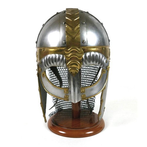 66 - A replica metal steel and brass helmet, with cheek plates, hinged ear flaps, and chain mail neck gua... 