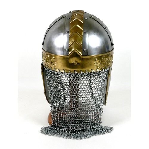 66 - A replica metal steel and brass helmet, with cheek plates, hinged ear flaps, and chain mail neck gua... 