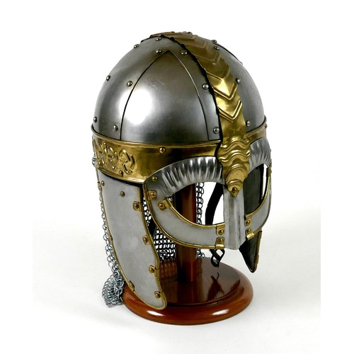 66 - A replica metal steel and brass helmet, with cheek plates, hinged ear flaps, and chain mail neck gua... 