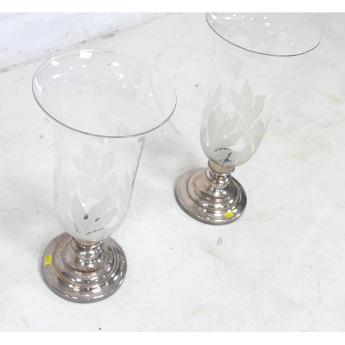 75 - A pair of modern candlesticks, with flared glass shades and engraved decoration, silver plated circu... 