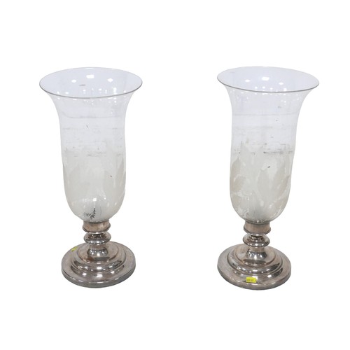 75 - A pair of modern candlesticks, with flared glass shades and engraved decoration, silver plated circu... 