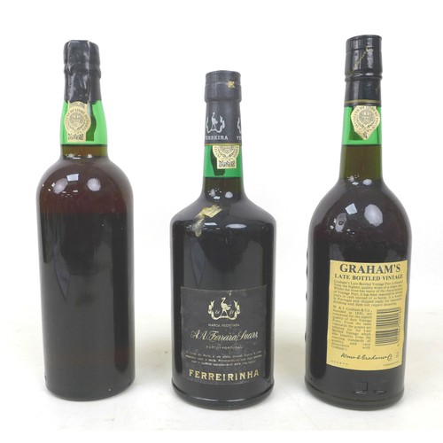 123 - Three bottles of vintage port, including a Kopke 1981, Ferreira Porto, and Graham's 1982. (3)