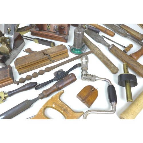 74 - A collection of vintage wooden tools, including a Holland wood plane, housed in a metal container. (... 