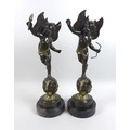 Two modern bronze sculptures, modelled as winged putti, cast in the Baroque style, one holding a fla... 