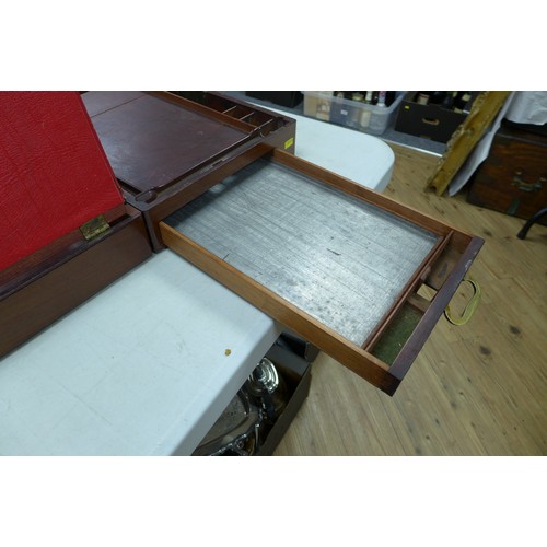 72 - A Georgian mahogany writing slope, with secret drawer and brass campaign handles, 44 by 29 by 13.5cm... 